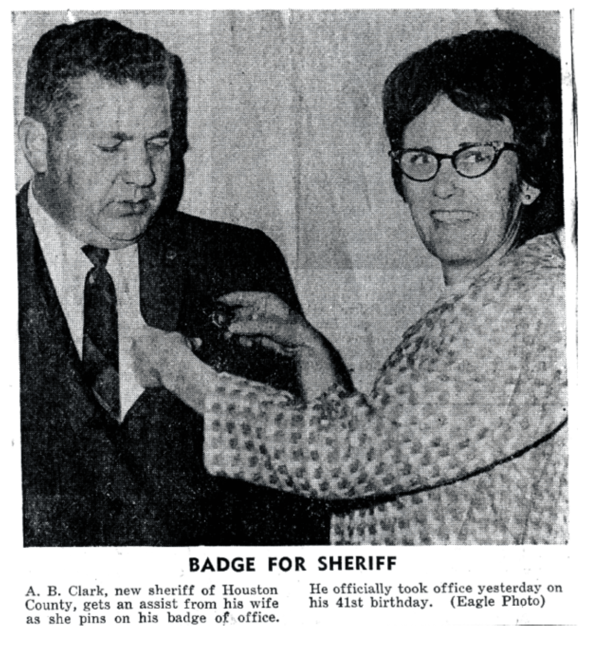 Black and white photo of a man and woman, with the caption "badge for sheriff"